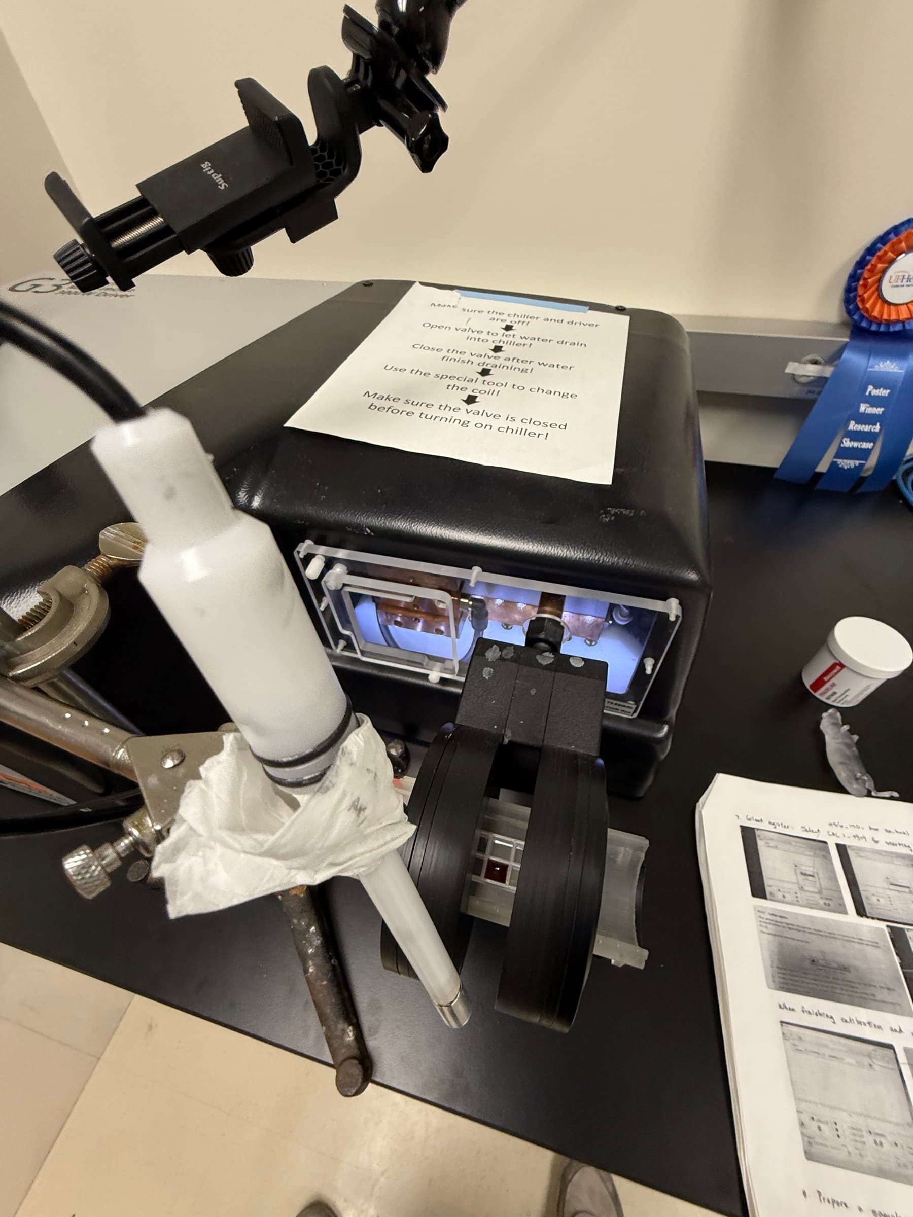 The full AMF applicator setup on the bench, including the coilset, transformer, cooler, and printed calibration notes.
